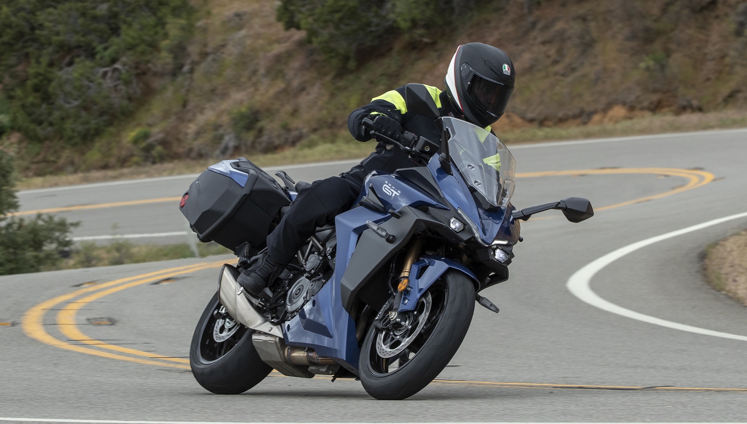 riding the Suzuki GSX-S1000GT+ on a curvy road