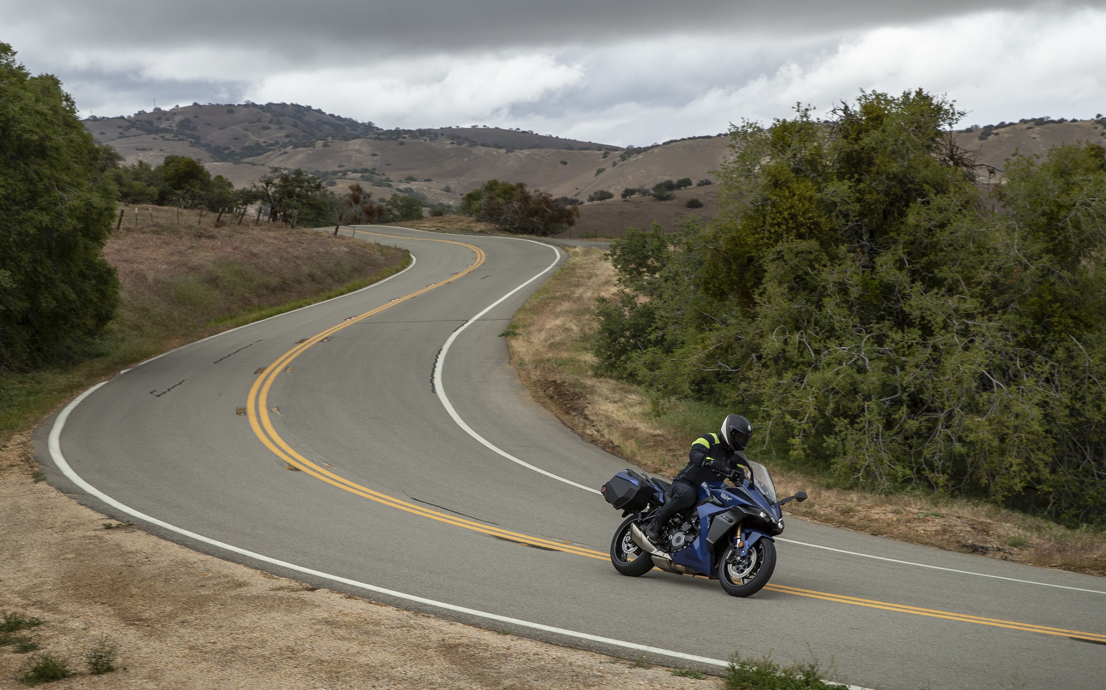 riding the GSX-S1000GT+ on a long and windy road