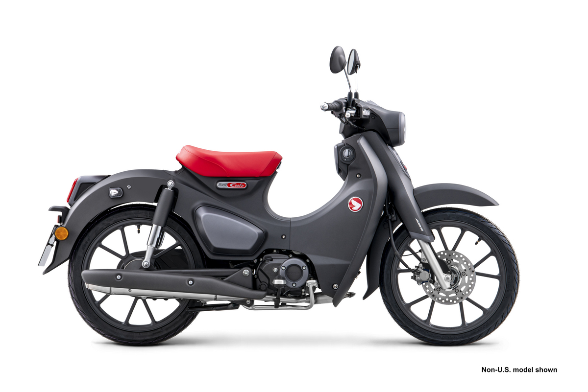 gray Honda Super Cub with a red seat